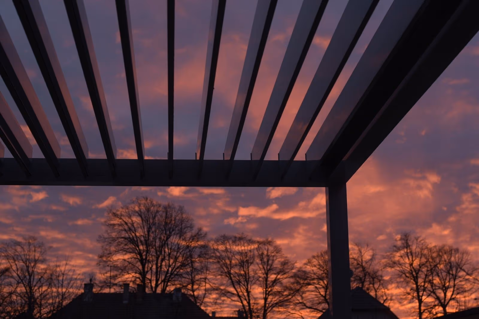 Bioklimatische Pergola mit drehbaren Lamellen bei Sonnenuntergang